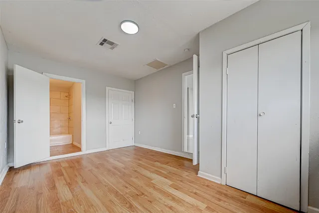 a view of empty room with wooden floor