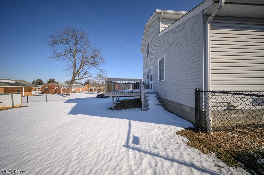 4431 7th Street Northwest Canton, OH 44708 - Photo 19 of 23 View of snowy exterior with a fenced backyard and a deck