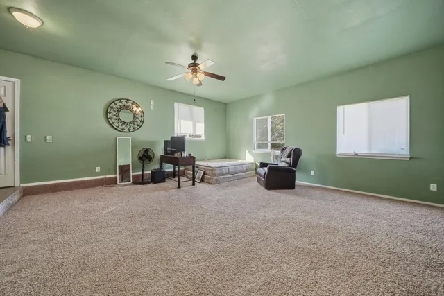 a view of a house with wooden deck and furniture