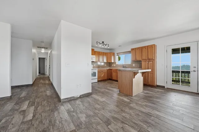 a view of a dining room with furniture and a window