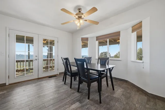 a kitchen with stainless steel appliances granite countertop a sink a stove a refrigerator cabinets and living room view