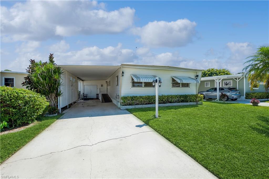 a front view of a house with a yard and porch