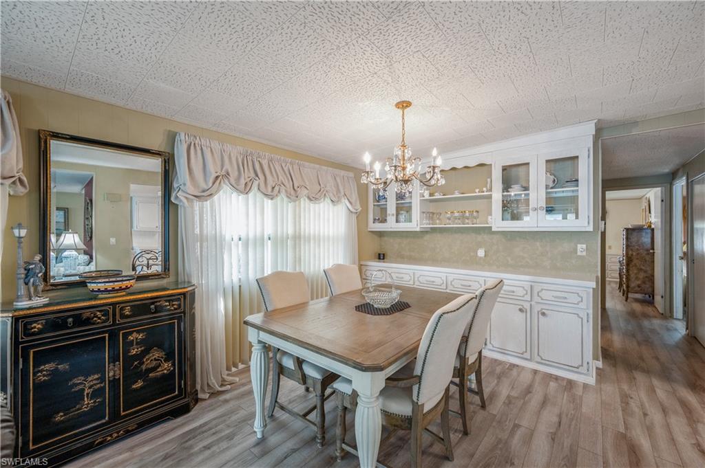 32 Monaco Terrace Naples, FL 34112 - Photo 11 of 19 a view of a dining room with furniture wooden floor and chandelier