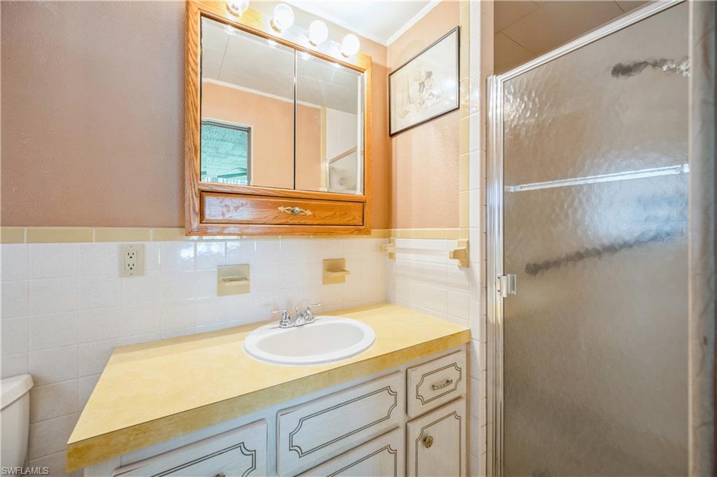 32 Monaco Terrace Naples, FL 34112 - Photo 13 of 19 a bathroom with a sink and a mirror