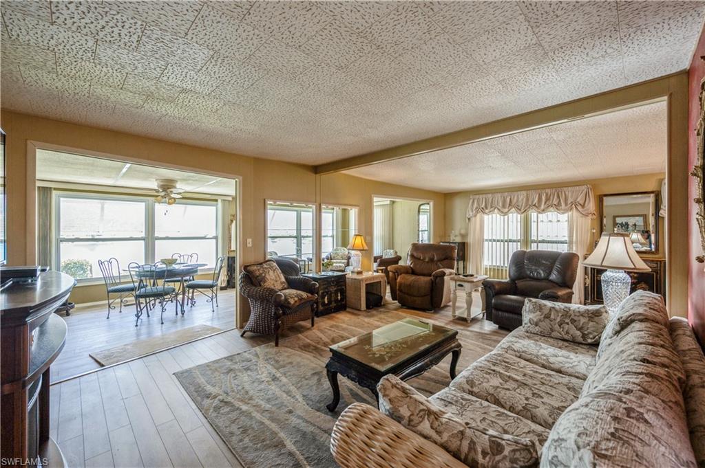 32 Monaco Terrace Naples, FL 34112 - Photo 2 of 19 a living room with furniture large window and table