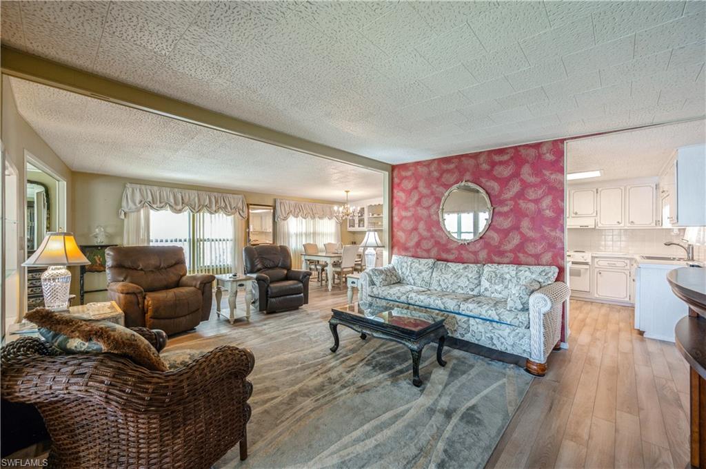 32 Monaco Terrace Naples, FL 34112 - Photo 3 of 19 a living room with furniture and wooden floor