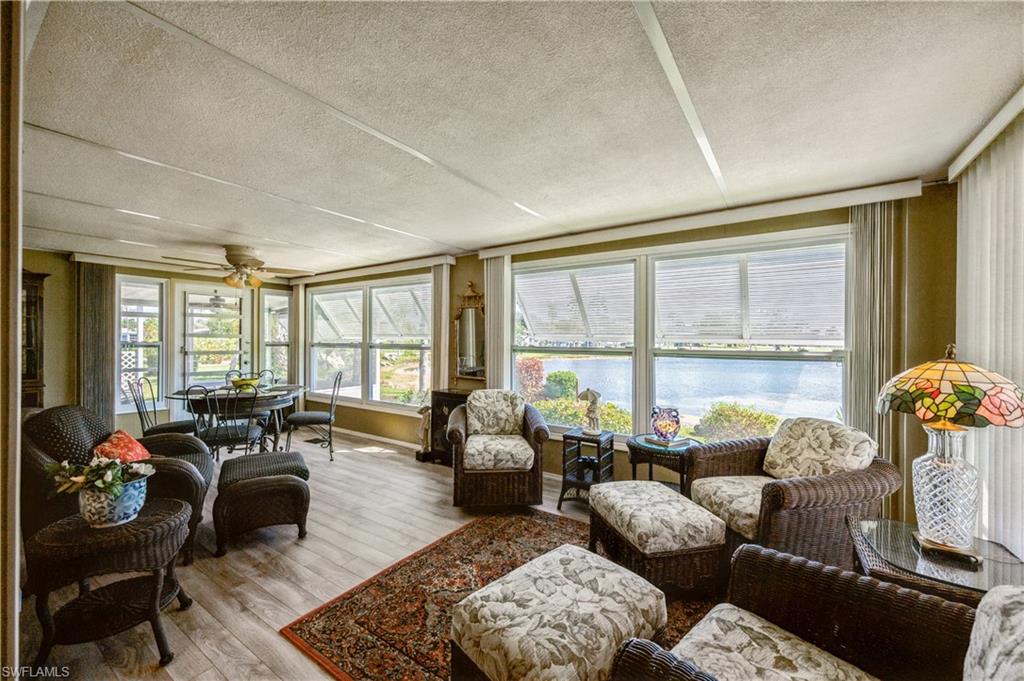 32 Monaco Terrace Naples, FL 34112 - Photo 4 of 19 a living room with furniture and large windows