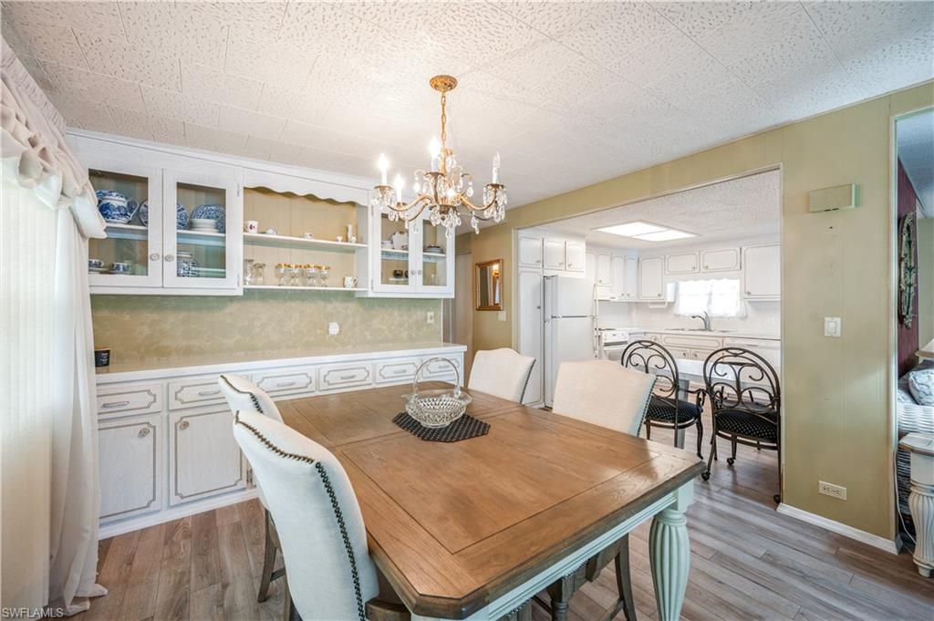 32 Monaco Terrace Naples, FL 34112 - Photo 8 of 19 a dining room with a table chairs and chandelier