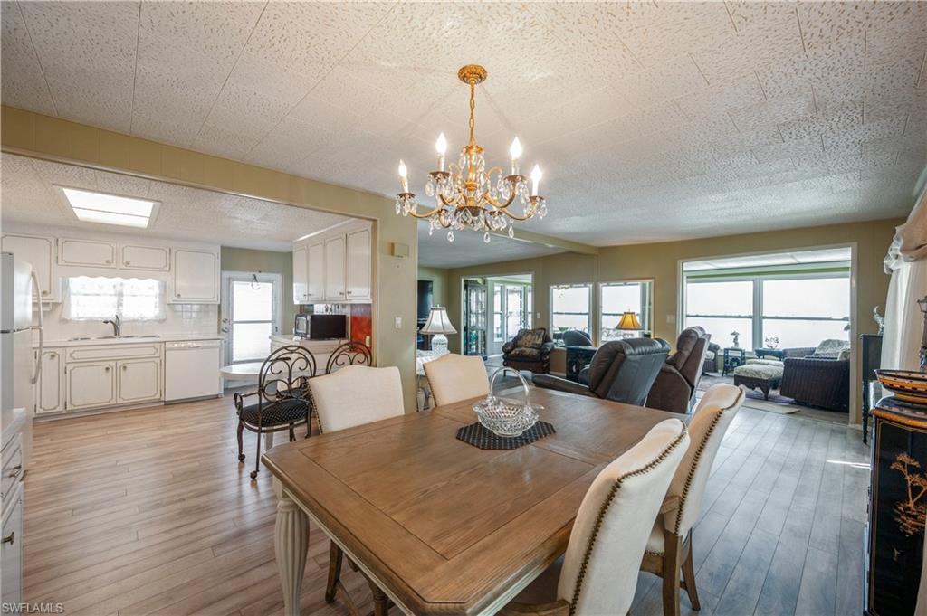 32 Monaco Terrace Naples, FL 34112 - Photo 9 of 19 a view of a dining room with furniture wooden floor and chandelier