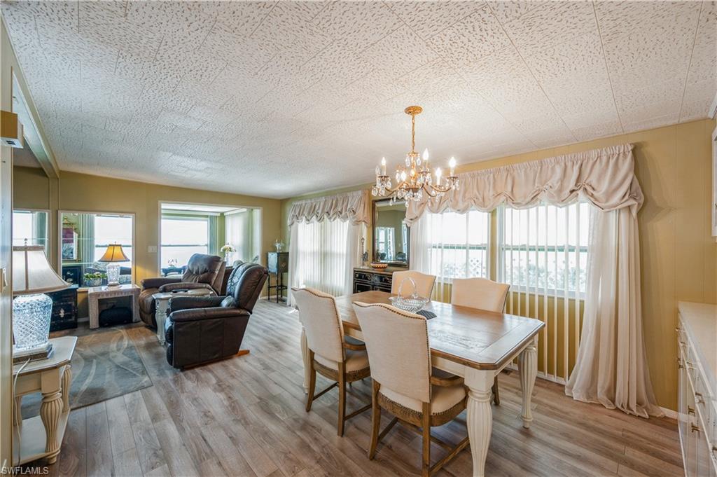 32 Monaco Terrace Naples, FL 34112 - Photo 10 of 19 a view of a dining room with furniture wooden floor and chandelier