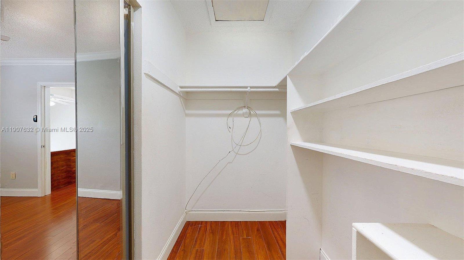 11339 Southwest 71st Street, Unit 11339 Miami, FL 33173 - Photo 12 of 28 a view of walk in closet with wooden floor