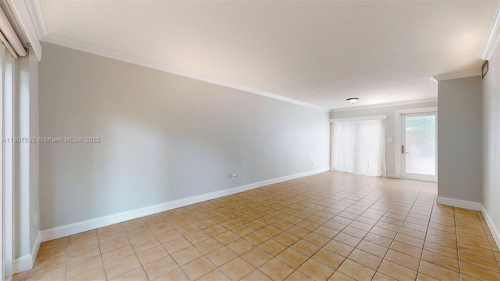 11339 Southwest 71st Street, Unit 11339 Miami, FL 33173 - Photo 17 of 28 a view of an empty room and window