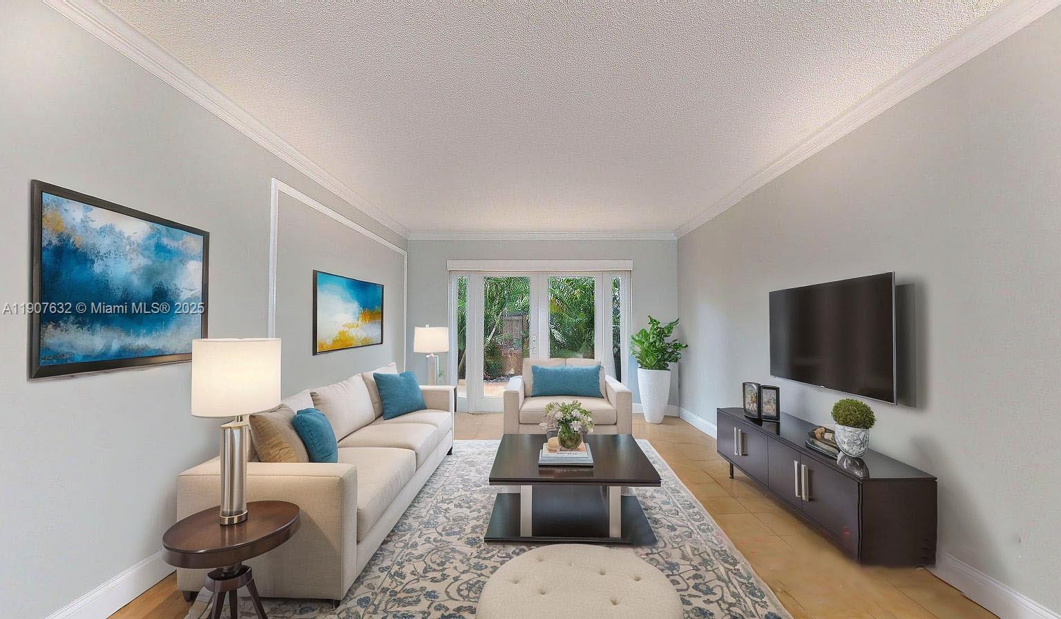 11339 Southwest 71st Street, Unit 11339 Miami, FL 33173 - Photo 18 of 28 a living room with furniture and a flat screen tv