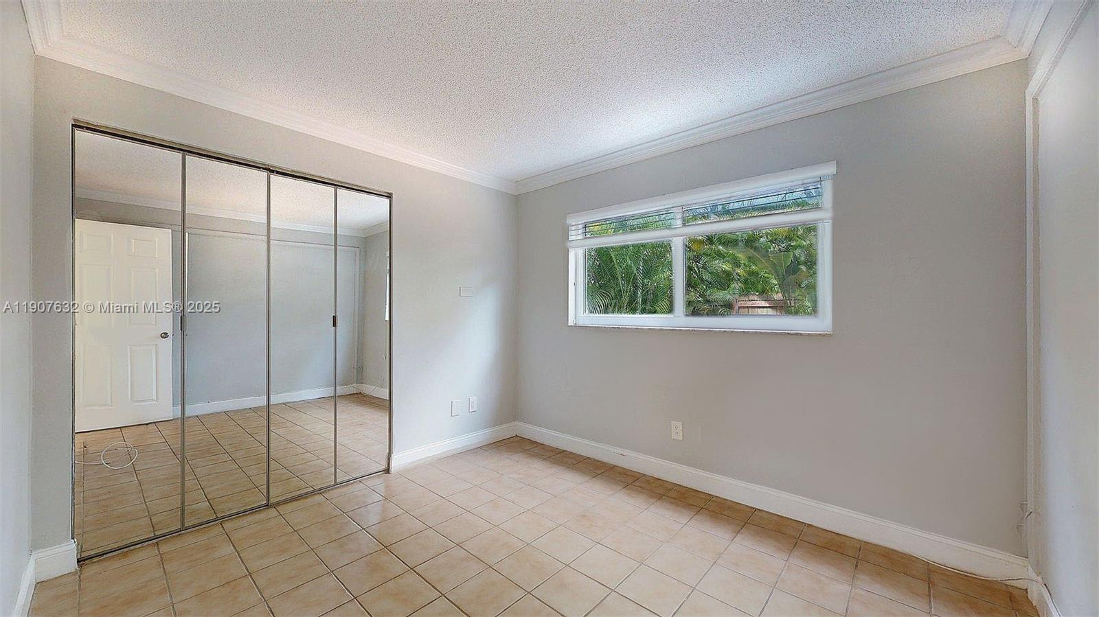 11339 Southwest 71st Street, Unit 11339 Miami, FL 33173 - Photo 23 of 28 a view of an empty room with window