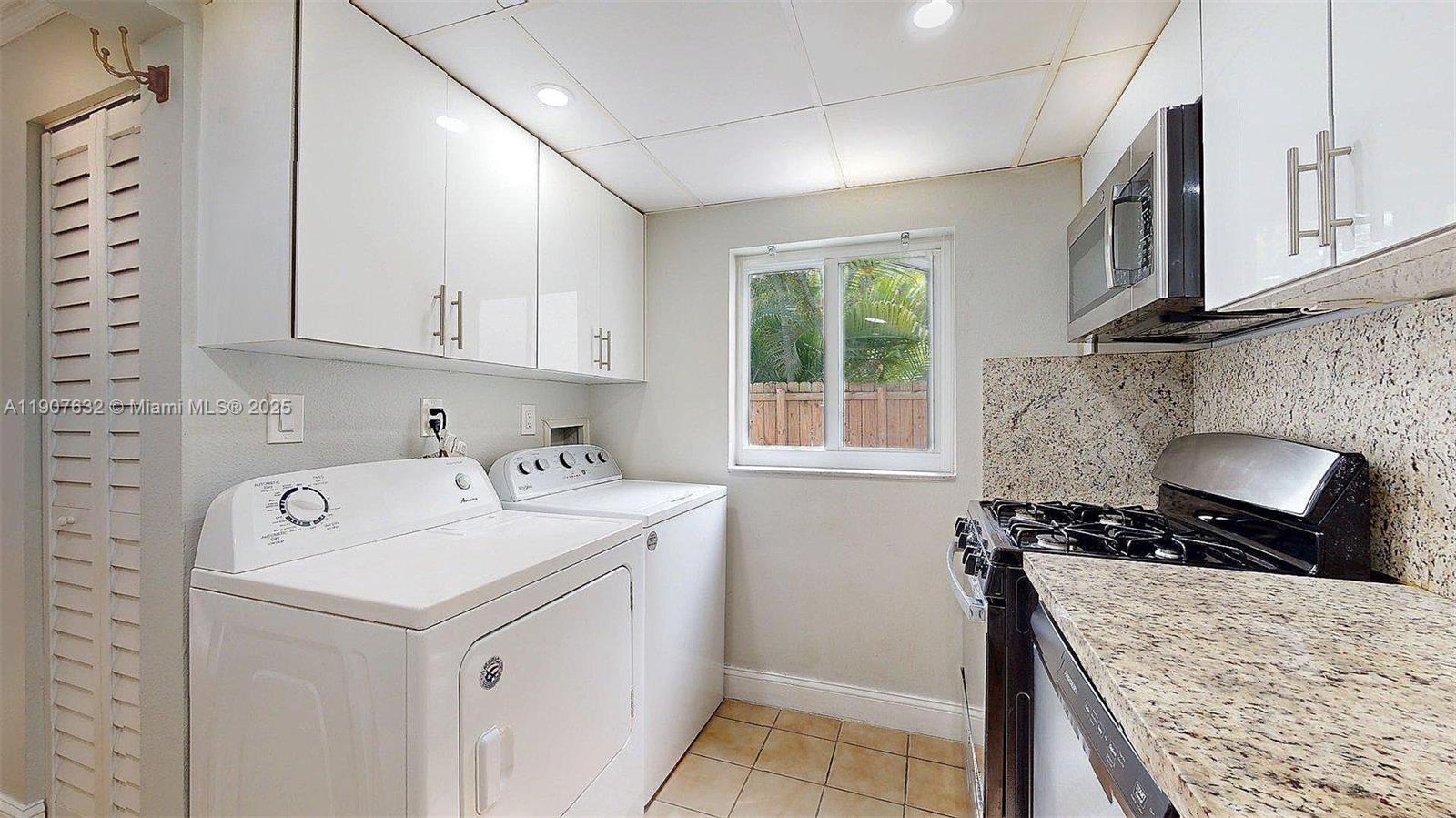 11339 Southwest 71st Street, Unit 11339 Miami, FL 33173 - Photo 26 of 28 a kitchen with a sink stove and cabinets