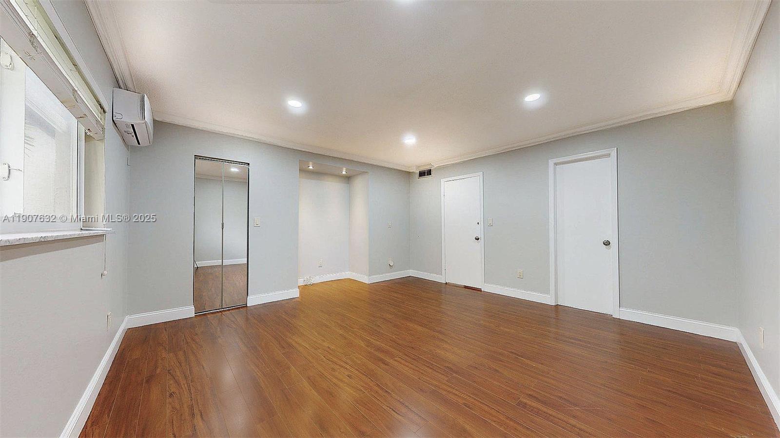 11339 Southwest 71st Street, Unit 11339 Miami, FL 33173 - Photo 5 of 28 a view of empty room with wooden floor