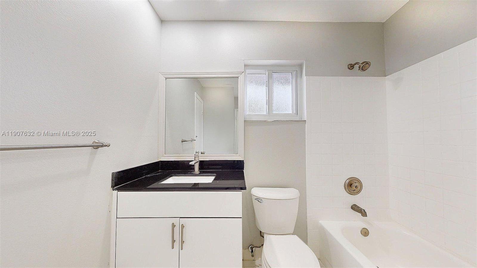 11339 Southwest 71st Street, Unit 11339 Miami, FL 33173 - Photo 9 of 28 a bathroom with a sink a toilet and shower