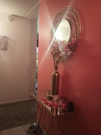 a room with a mirror and fan