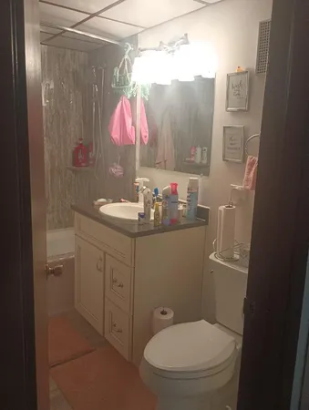a bathroom with a sink toilet and shower