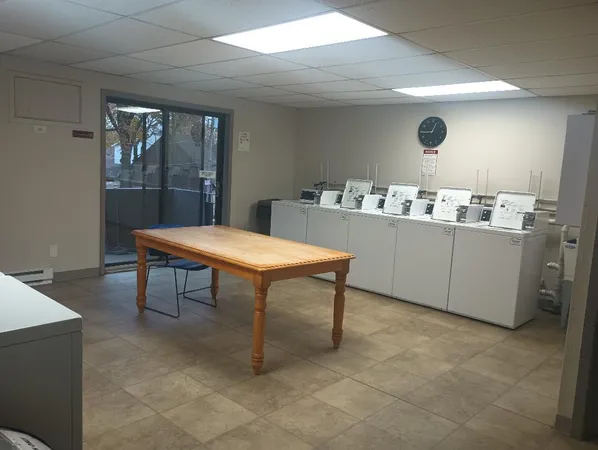 a room with table chairs and wooden floor