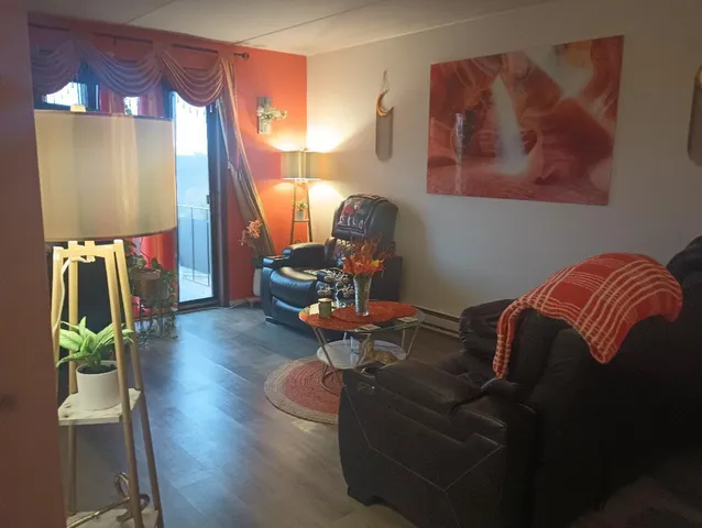 a living room with furniture and a lamp