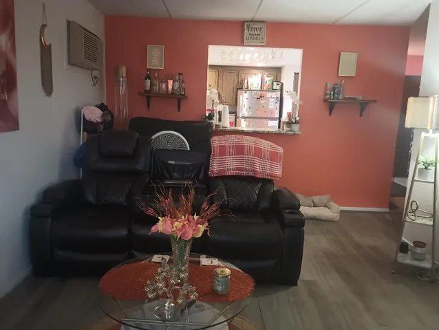 a living room with furniture a fireplace and a chandelier