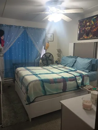 a bedroom with a bed and a window