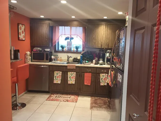 a kitchen with stainless steel appliances granite countertop a sink stove and cabinets