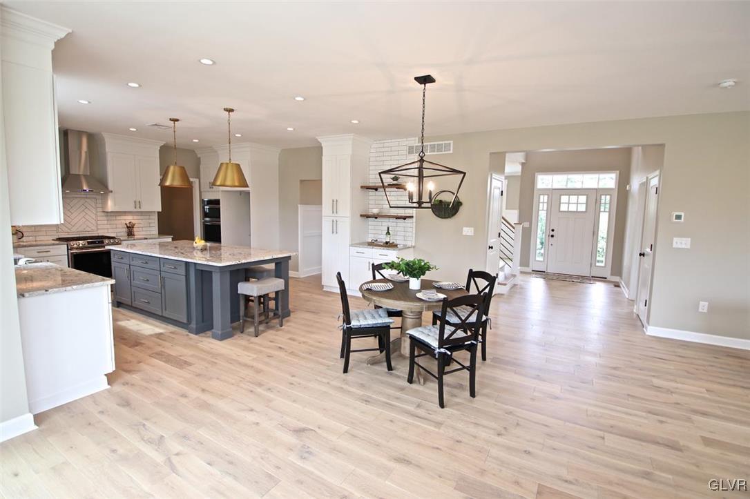 650 Clearfield Road Nazareth, PA 18064 - Photo 14 of 50 a view of a dining room and livingroom with furniture wooden floor a chandelier
