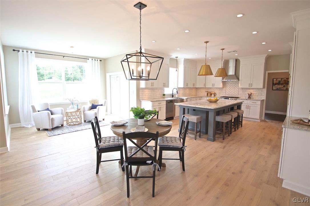 650 Clearfield Road Nazareth, PA 18064 - Photo 15 of 50 a view of a dining room and livingroom with furniture wooden floor a chandelier
