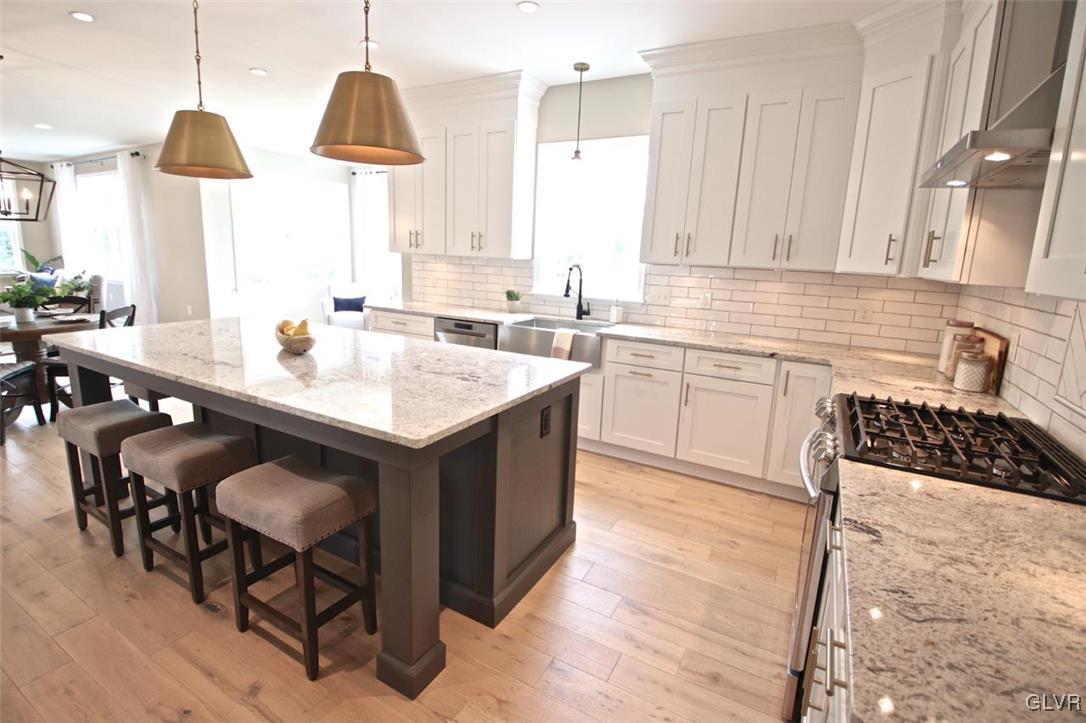 650 Clearfield Road Nazareth, PA 18064 - Photo 47 of 50 a kitchen with a sink a stove a dining table and chairs