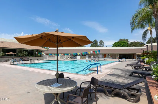 a view of house with backyard outdoor seating area and furniture