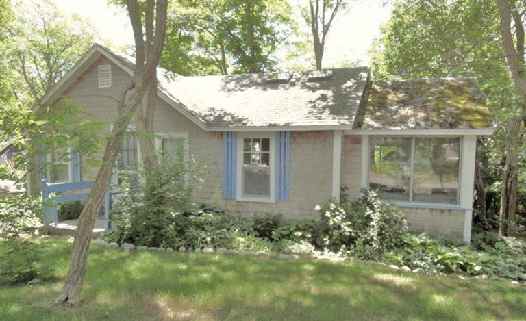 215 Pilgrim Spring Road, Unit 1 Wellfleet, MA 02667 - Photo 3 of 14 a view of brick house with a yard and potted plants