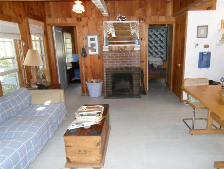 215 Pilgrim Spring Road, Unit 1 Wellfleet, MA 02667 - Photo 6 of 14 a living room with furniture and a fireplace