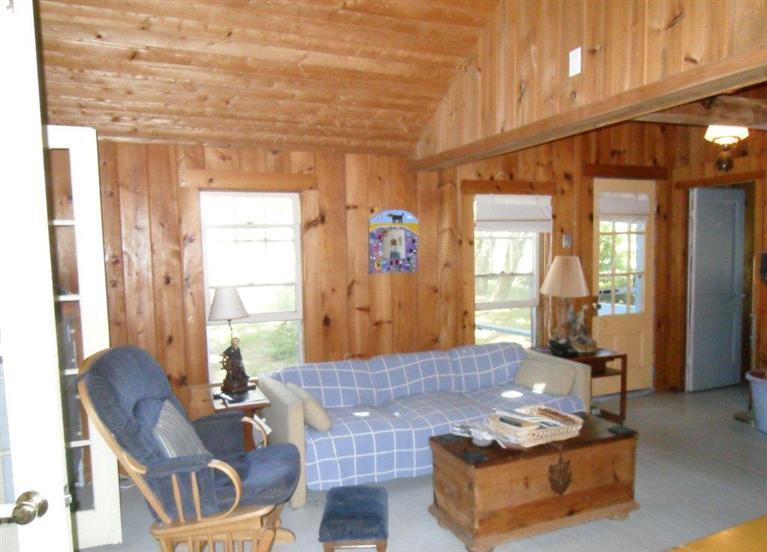 215 Pilgrim Spring Road, Unit 1 Wellfleet, MA 02667 - Photo 7 of 14 a living room with furniture and a large window