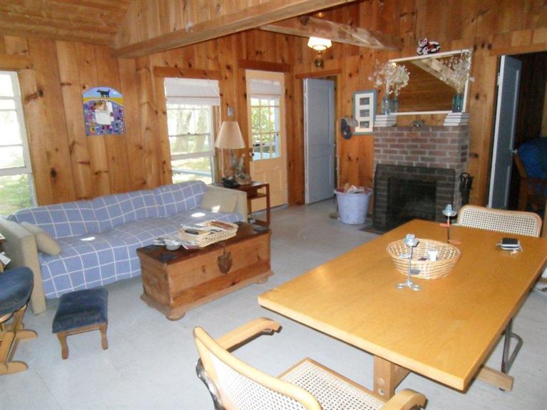 215 Pilgrim Spring Road, Unit 1 Wellfleet, MA 02667 - Photo 8 of 14 a living room with furniture pool table and a fireplace