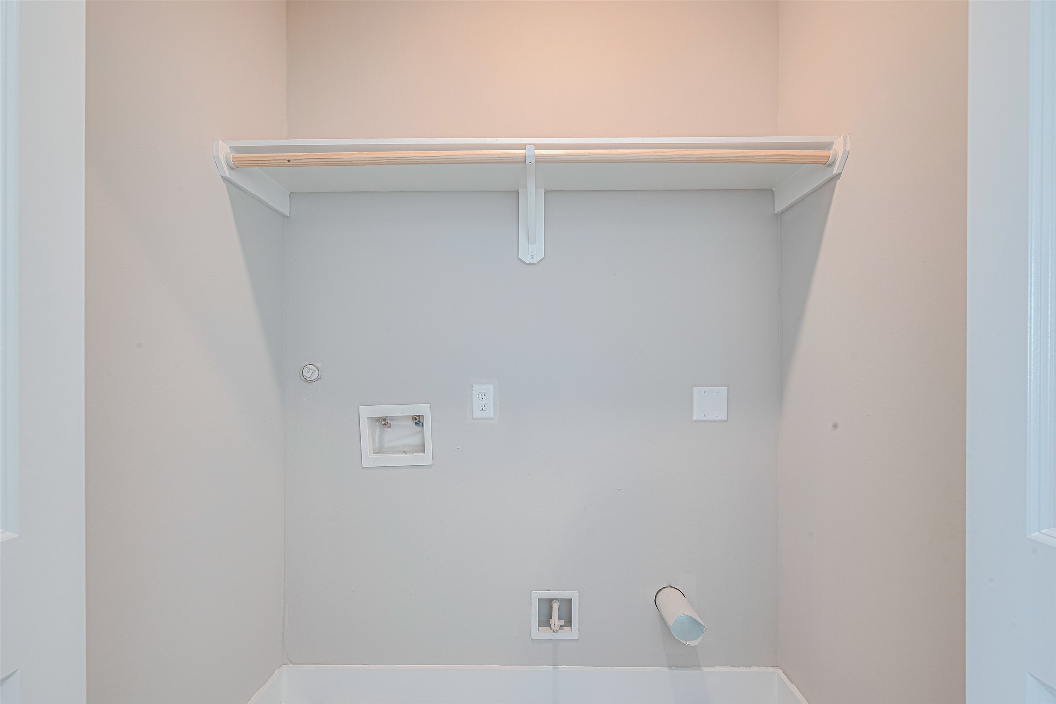 7207 Force Street Houston, TX 77020 - Photo 9 of 29 Laundry area with hookups for a washer and dryer, featuring a wooden shelf for storage above.