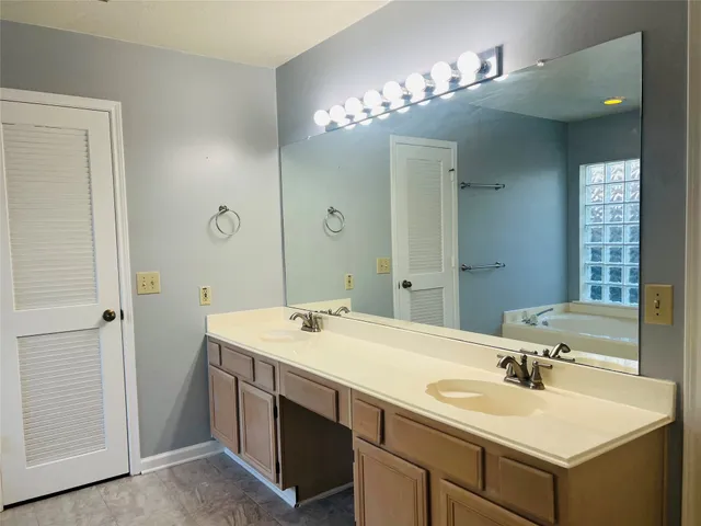 a bathroom with a bathtub and shower