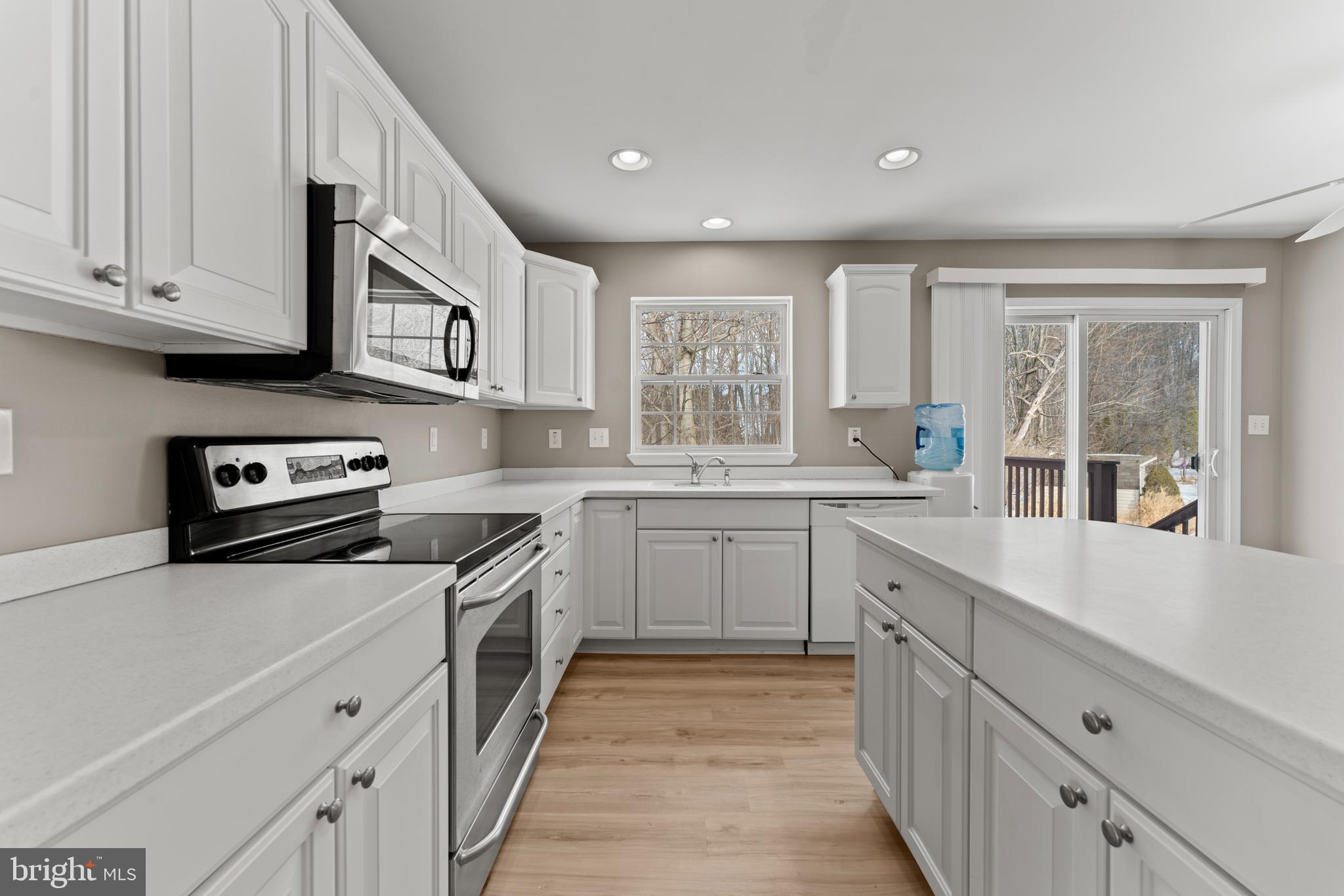 7756 Seneca Ridge Drive York, PA 17403 - Photo 21 of 50 a kitchen with granite countertop white cabinets and white appliances