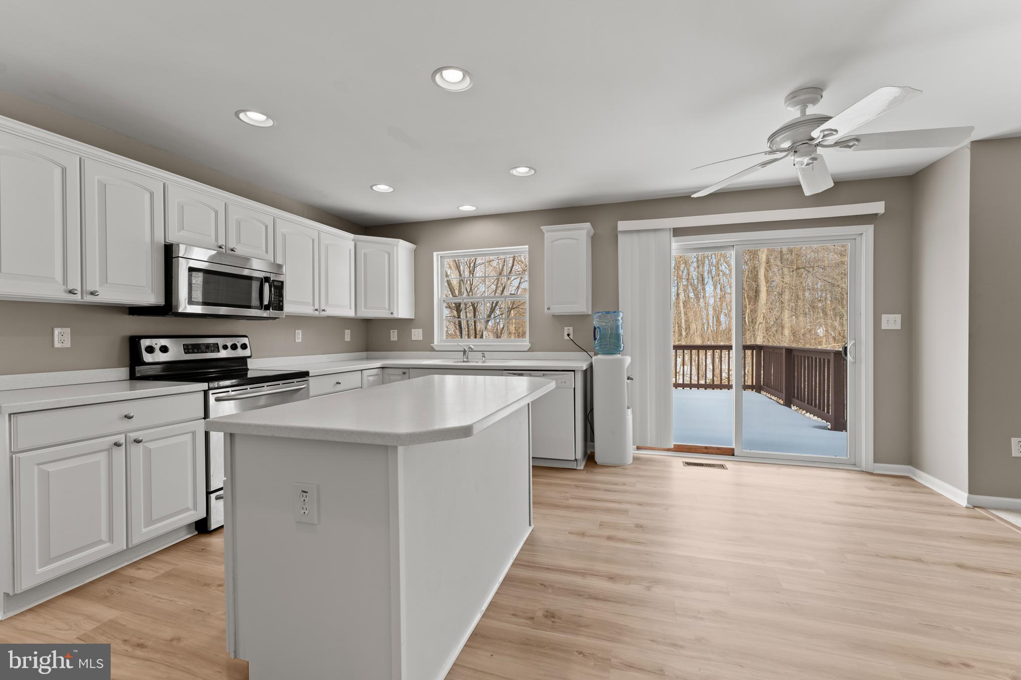 7756 Seneca Ridge Drive York, PA 17403 - Photo 23 of 50 a large kitchen with kitchen island a large counter top space a sink stainless steel appliances and cabinets