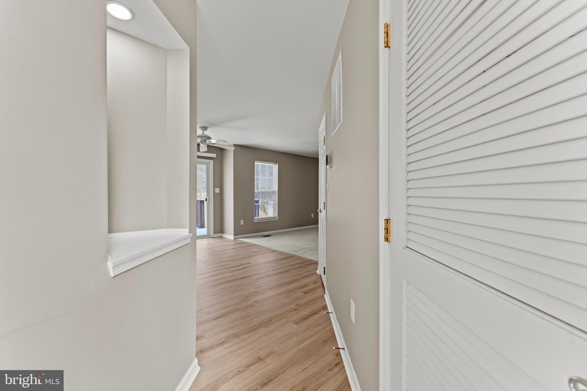 7756 Seneca Ridge Drive York, PA 17403 - Photo 26 of 50 a view of a hallway with wooden floor and staircase