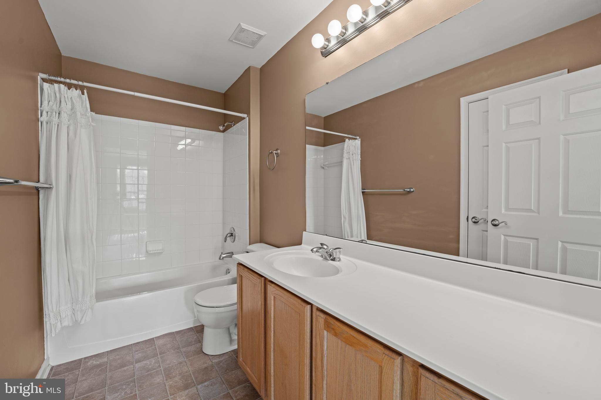 7756 Seneca Ridge Drive York, PA 17403 - Photo 33 of 50 a bathroom with a double vanity sink toilet mirror and shower