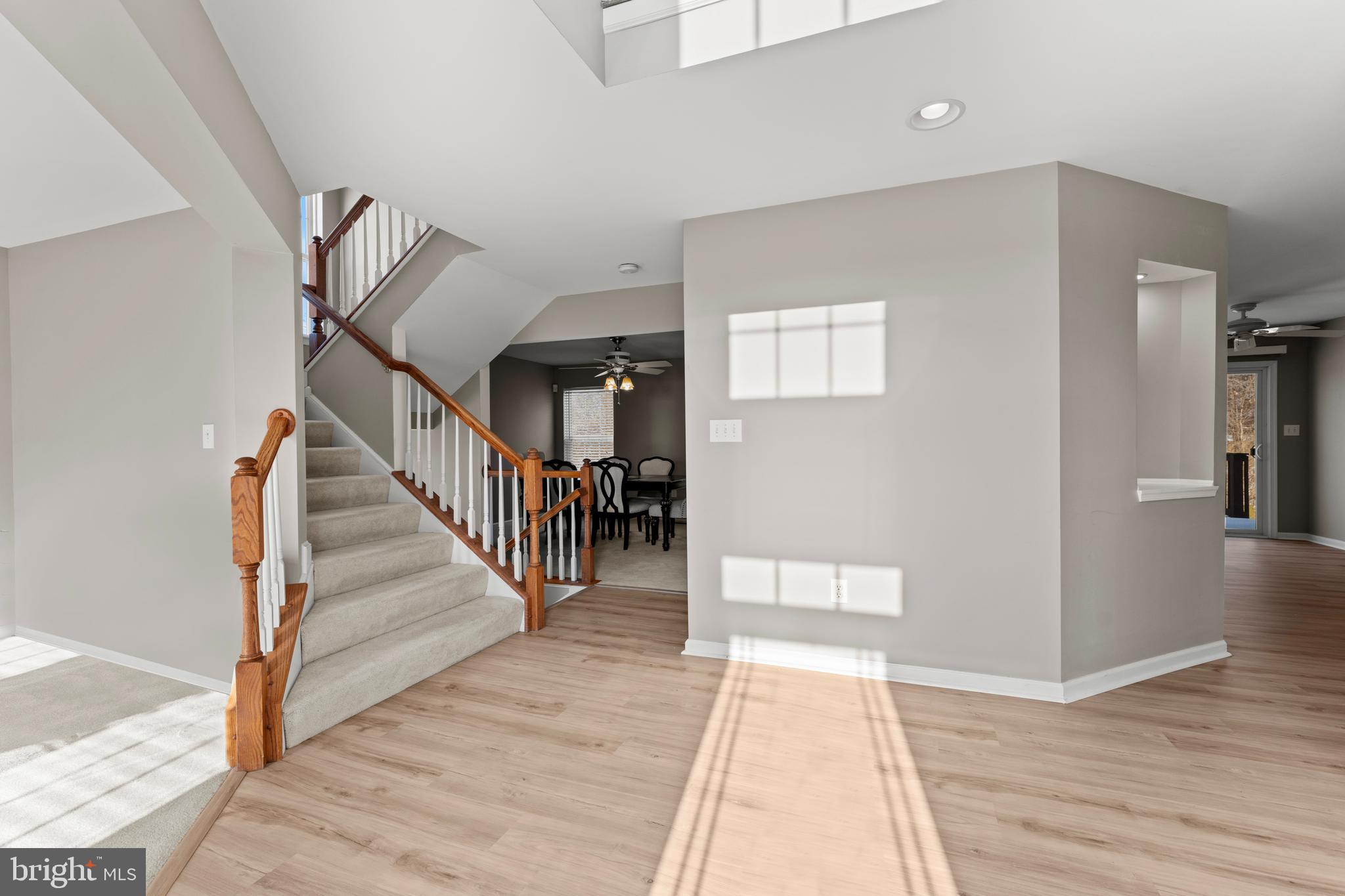 7756 Seneca Ridge Drive York, PA 17403 - Photo 4 of 50 a view of a hallway with wooden floor and staircase