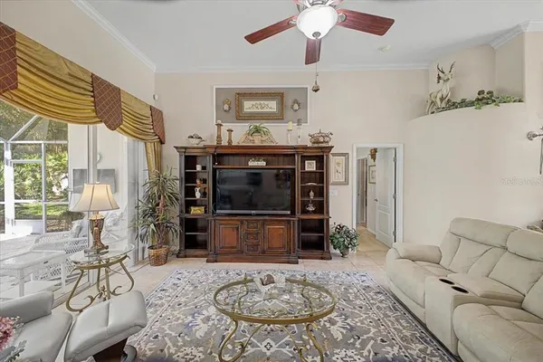 a dining room with furniture a chandelier and a floor to ceiling window
