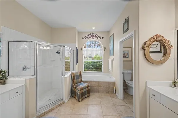 a bathroom with a shower sink and mirror