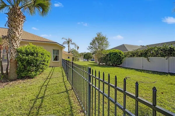 an aerial view of a house with a yard and large trees