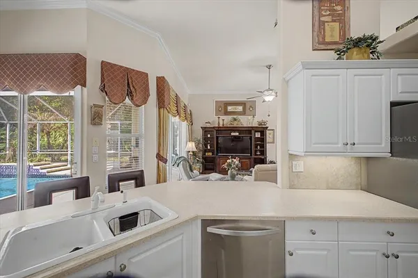 a kitchen with stainless steel appliances kitchen island sink refrigerator and stove