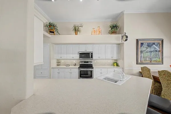 a kitchen with furniture a sink and a stove top oven
