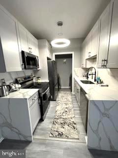 a kitchen with stainless steel appliances kitchen island granite countertop a sink stove and cabinets