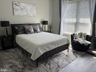 1581 Spring Gate Dr., Unit 5403 McLean, VA 22102 - Photo 13 of 16 a bedroom with a bed and wooden floor